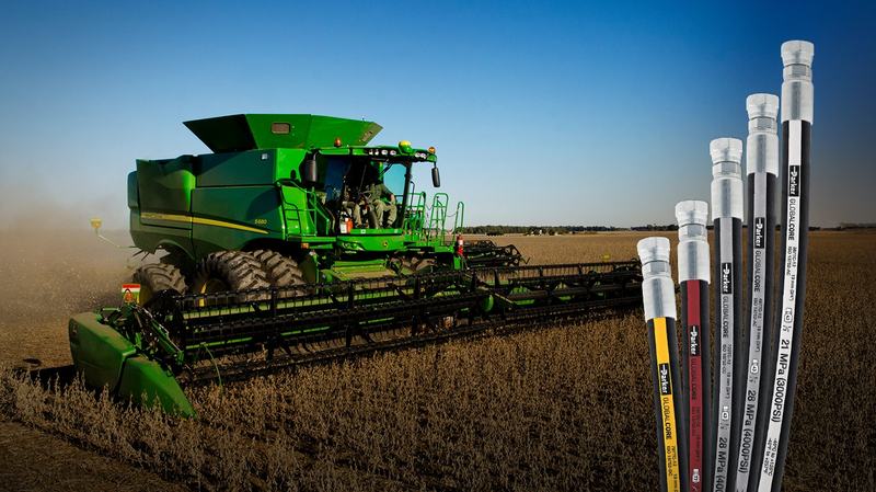 Mangueras hidráulicas con terminales metálicos y una cosechadora John Deere al fondo